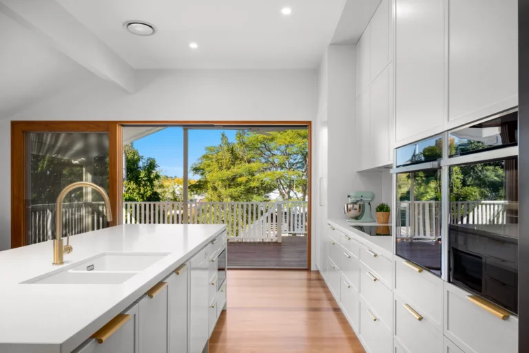 Modern kitchen with island, large windows, and outdoor view