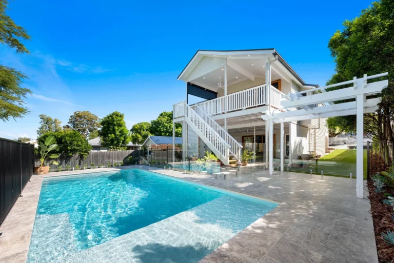 Modern two-story home with backyard pool and patio.